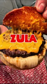 A creator visits ZULA Burger in Central London to test if the viral burger lives up to the hype. The video features a review of the basic beef burger, skin-on fries, and a standout San Sebastián cheesecake, with the creator concluding that while the burger is good but small, the cheesecake is exceptional.