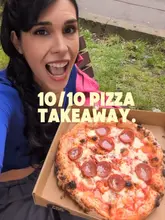 A short, punchy video featuring a wood-fired pizza truck called Doughman's Land located in Kelvingrove Square, Glasgow. The video highlights the menu, the cooking process, and the final product, encouraging viewers to visit for a casual takeaway meal.