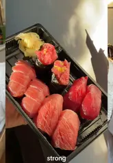 A creator reviews a high-quality takeaway sushi set from Guru Guru in Angel, London, demonstrating the freshness and quality of the fish and sharing her personal experience.