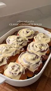 A step-by-step recipe tutorial for making cinnamon rolls, featuring close-up shots of the dough preparation, rolling, baking, and frosting application.