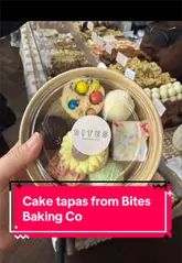 The creator visits the Crafty Bazaar at Wylam Brewery to find a local vendor, Bites Baking Co, which offers a 'cake tapas' service. The video features the creator interacting with the vendor, selecting various small cake portions, and tasting a pistachio cake pop, highlighting the variety and appeal of the products.