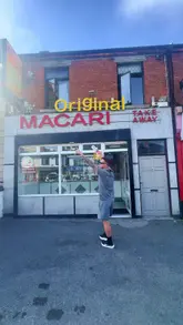 A high-energy vlog review of 'The Original Macari' in Inchicore, showcasing a wide variety of classic chipper takeaway items including kebabs, burgers, and battered snacks.