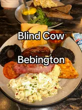 A vlog-style review of the Blind Cow cafe and steakhouse in Bebington, featuring a tour of the interior, a look at the menu, and a showcase of their breakfast and coffee offerings.