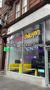 A creator and a child visit Chunky Chicken in Glasgow to review their pizza, burgers, and chicken wings, while also highlighting an upcoming launch of smash burgers.
