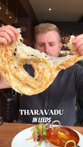 A couple visits Tharavadu in Leeds to review their Keralan cuisine, showcasing various dishes including beef, prawns, fish curry, chicken curry, duck roast, and lamb chops, ending with a birthday surprise.