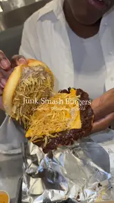 A vlog-style review of Junk Smash Burgers, showcasing their menu including panko chicken, smash burgers with peppercorn sauce, fries, and cookies.