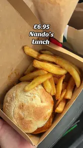 A creator reviews a £6.95 lunch deal from Nando's, showing the contents of the takeaway bag while sitting in a car.