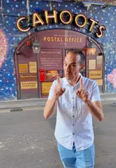 A creator visits Cahoots Postal Office in London, showcasing its 1940s post-war theme, unique pneumatic cocktail delivery system, and a hidden nightclub feature in the restroom.