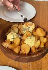 A vibrant, fast-paced vlog documenting a visit to Bar Kroketa in London. The video features a variety of shots including the busy venue interior, close-ups of various tapas dishes like croquetas and patatas bravas, cocktails, and the creator interacting with staff. The editing is energetic and captures the social, lively atmosphere of the restaurant.