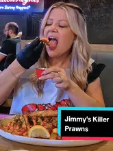 A review video of Jimmy's Killer Prawns in Milton Keynes, featuring a couple trying various dishes including a prawn boil, prawn mac and cheese, and a surf and turf stack.