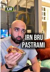 A candid review of the Irn Bru Pastrami sandwich from Primal Feast in Glasgow, featuring a taste test and commentary on the unique flavor profile, alongside other menu items like pizza and lamb chips.