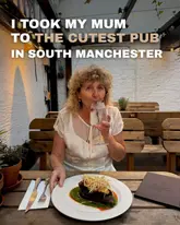A photo of a woman dining at a pub, featuring a steak dish and a drink, with text overlay promoting the venue.