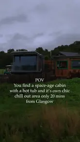 A video tour of a modern, tech-enabled glass pod cabin in Scotland, highlighting its floor-to-ceiling windows, projector screen, and private hot tub.