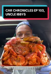 A creator reviews a £50 seafood boil takeaway from Uncle Ibby's in Tulse Hill, filmed from his car. He demonstrates the provided apron and gloves, tastes the various seafood items including lobster tail, crab legs, mussels, corn, and egg, and provides enthusiastic commentary on the flavour and quality.