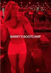 A candid vlog following a couple's experience at a Barry's Bootcamp class in London, highlighting the high-intensity workout, the red-lit studio environment, and the post-workout recovery shakes.