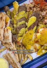 A vlog-style review of Zeus Greek Street Food in Glasgow, featuring two creators trying various dishes including cheese fritters, feta sticks, loaded fries, and Greek donuts.