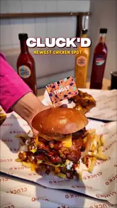 A promotional reel showcasing the food and interior of the newly opened Cluck'd restaurant in Leicester, featuring close-ups of burgers, loaded fries, and chicken dishes.