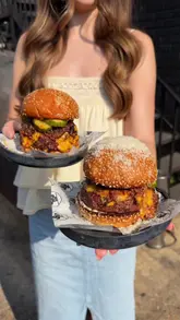 A creator reviews Black Cactus BBQ, highlighting their smoked burgers, chicken legs, and unique desserts at Burnt Faith Brand House in Walthamstow.