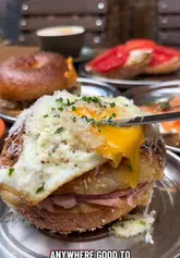 A creator reviews a new bagel shop in Salford, Manchester, highlighting the quality of the bagels, the variety of fillings, and the overall atmosphere of the venue.
