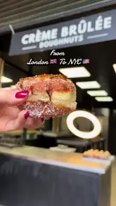 A short, high-quality video showcasing the preparation and texture of crème brûlée doughnuts at a Bread Ahead stall in Borough Market, highlighting the torching process and the creamy interior.