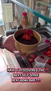 A short, first-person video showcasing a new self-serve acai bowl bar, highlighting the variety of toppings and additional dessert options like frozen yogurt and overnight oats available to customers.