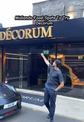 A fast-paced, engaging vlog-style review of Decorum in Birmingham, showcasing the venue's upscale interior, cocktails, and a variety of dishes including prawns, bao buns, short rib, steak, and a burger with lobster tail.