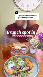 A vlog-style review of a brunch cafe in Manchester, showcasing various dishes like steak and eggs, French toast, and unique coffee, along with the venue's interior.