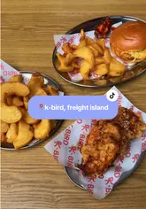 A promotional video for K-Bird at Freight Island Newcastle, featuring close-ups of their double-fried Korean chicken, burgers, and fries, with the creator sharing their positive experience.