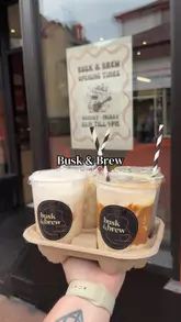 A review of various iced drinks at Busk & Brew in Neath, featuring the creator trying and rating several menu items including a butterbeer-inspired drink, iced lattes, and a refresher.