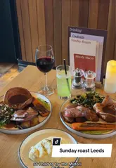Two creators visit The Wardrobe in Leeds to review their Sunday roast menu, showcasing the beef roast, sides like truffle mash, and cocktails.