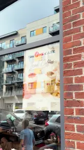 A casual review of The One Cafe, showcasing the menu, an iced coffee, and the Giggs Benedict dish.