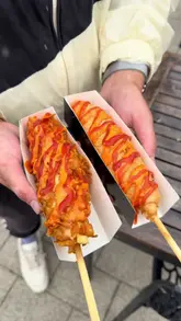 A fast-paced vlog showcasing a visit to the 'Feast Street' food festival at Meadowhall, featuring a variety of street food vendors including Japanese steak sandos, birria tacos, corn dogs, and desserts.