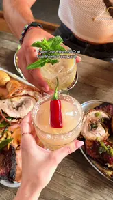 A vibrant reel showcasing a BBQ-twist Sunday roast at From The Ashes BBQ in Hackney. The video features close-ups of a smoked pork doughnut starter, a generous sharing tray with beef featherblade, spitting pig, and chicken, alongside cocktails and the venue's outdoor courtyard setting.