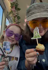 A mother and daughter vlog their journey on a Southeastern train to London, followed by a Taylor Swift-themed afternoon tea bus tour. The video highlights the 2-for-1 offer available through the train operator, showcasing the bus interior, the food, and the sightseeing experience.