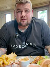 A creator reviews a new double smash burger special at The Devonshire Arms, highlighting the ingredients and offering a discount code for bookings.