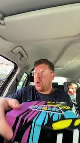 A creator reviews food from 'Craft Burger' while sitting in a car. He samples loaded fries, doner meat, and a cheeseburger, providing his commentary on the taste and quality of the takeaway meal.