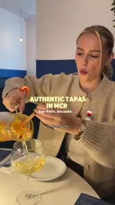 A creator visits Can Petit in Ancoats, Manchester, to review their authentic tapas menu. The video features a variety of dishes including croquettes, prawns, patatas bravas, an oxtail sandwich, and French toast, alongside sangria. The creator provides commentary on the quality and authenticity of the food, highlighting the shareable nature of the plates and the welcoming atmosphere.