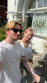 A couple visits the newly opened Olympia Rooftop in London with their baby, showcasing the venue's architecture, the Wolves of Tokyo restaurant, and their lunch experience featuring Japanese bento boxes and mocktails.