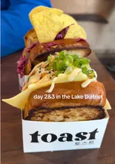 A personal travel vlog documenting a two-day trip to the Lake District, featuring accommodation in a cabin, boat hire on Lake Windermere, a visit to a sandwich shop called Toast, a Christmas shop, and an ice cream parlour.