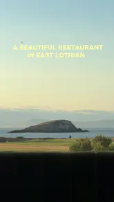 A review of The Lawn at the Marine Hotel in North Berwick, East Lothian. The video features a voiceover narration guiding the viewer through the menu, including starters like scallops and beetroot salad, mains like lamb and ox cheeks, and desserts like cheesecake, all while highlighting the scenic coastal views from the restaurant.