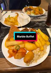 A montage video showcasing the variety of food available at Marble Global Buffet in Hamilton, featuring pasta, pizza, fried chicken, ribs, and a chocolate fountain.