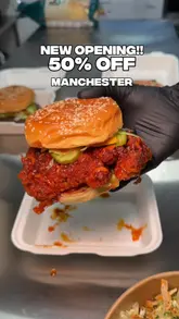 A promotional video for the reopening of 0161 Flamin Fusion in Ardwick Kitchens, Manchester. The video features the creator showcasing various menu items including burgers, loaded fries, and fried potatoes, while highlighting a 50% off opening offer.