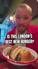 A creator visits Banjax Burger in Spitalfields Market to review their signature burger. The video features the creator talking to the camera, showing the menu, the payment process, and his reaction to the food, specifically highlighting the peppercorn sauce.