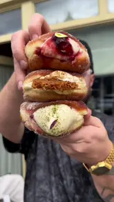 The creator visits three different bakeries in Sheffield, reviewing various pastries and doughnuts, including a vegan option. The video features close-up shots of the food, the storefronts, and the creator's reactions.