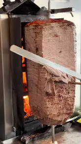 A food review video featuring a visit to 'Londöner by Best Mangal' to try their yaprak doner kebab. The creator showcases the preparation of an Iskender kebab and a wrap, providing commentary on the quality of the meat and the overall experience.