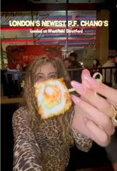 A fast-paced, energetic reel showcasing the launch party of the new P.F. Chang's restaurant at Westfield Stratford. The video features the creator trying various dishes, including sushi, spring rolls, and their signature dynamite shrimp, while highlighting the lively atmosphere with a live saxophonist, magician, and traditional lion dance performance.