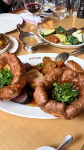 A detailed review of the Sunday roast experience at Maison Francois, featuring the food, wine, and dessert trolleys. The creator highlights the unique Anglo-French menu, including escargot Yorkshire puddings and various meats, while providing commentary on the quality and value of the meal.